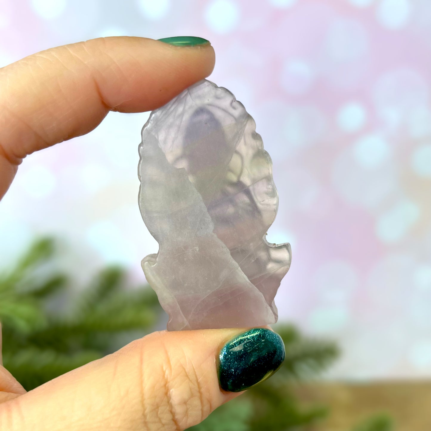 a person holding a piece of glass in their hand