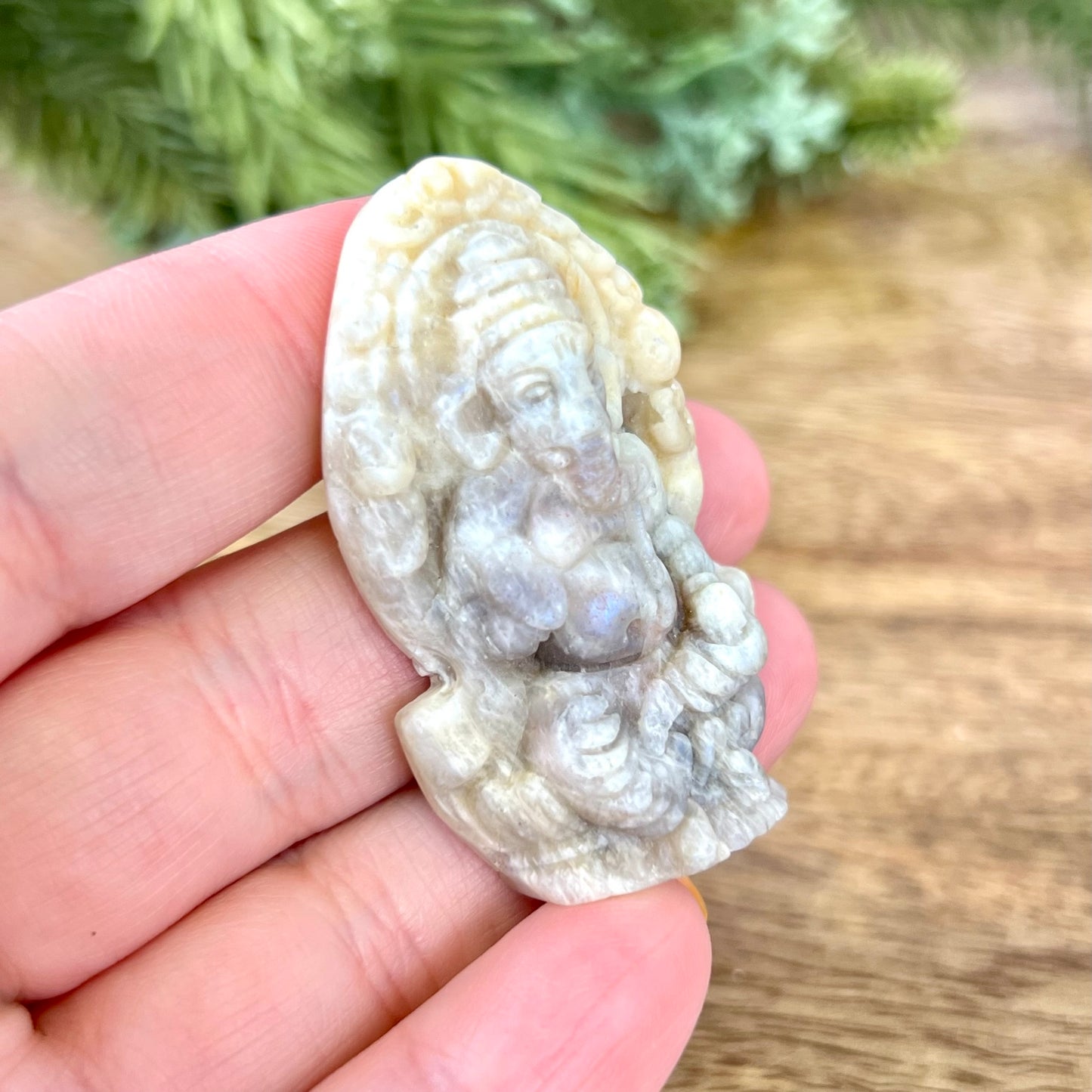 a person is holding a small carved animal