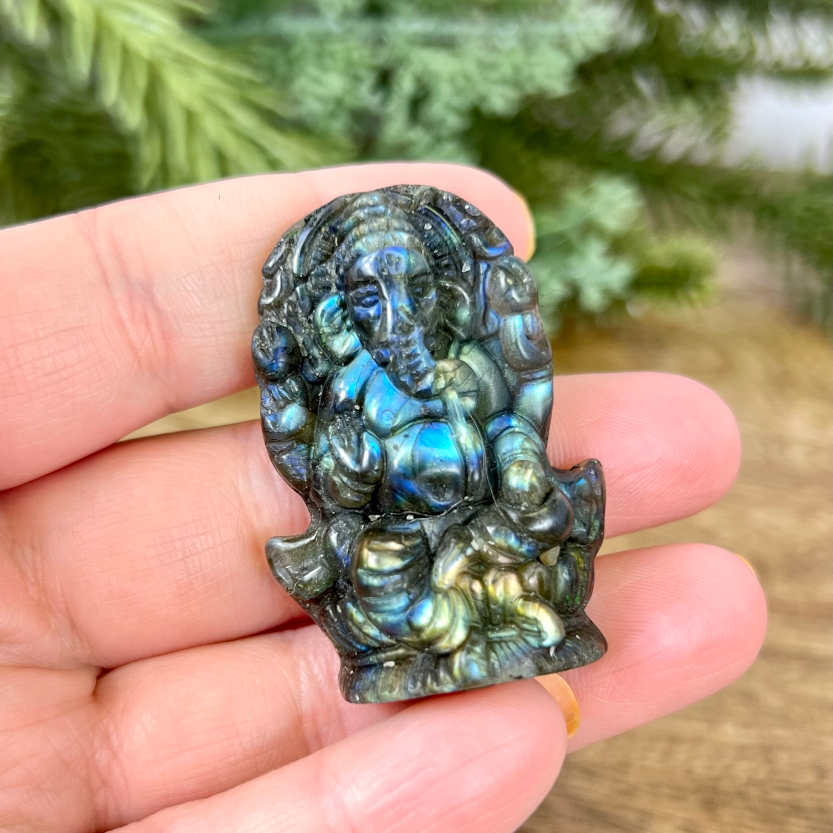 a person holding a small statue in their hand