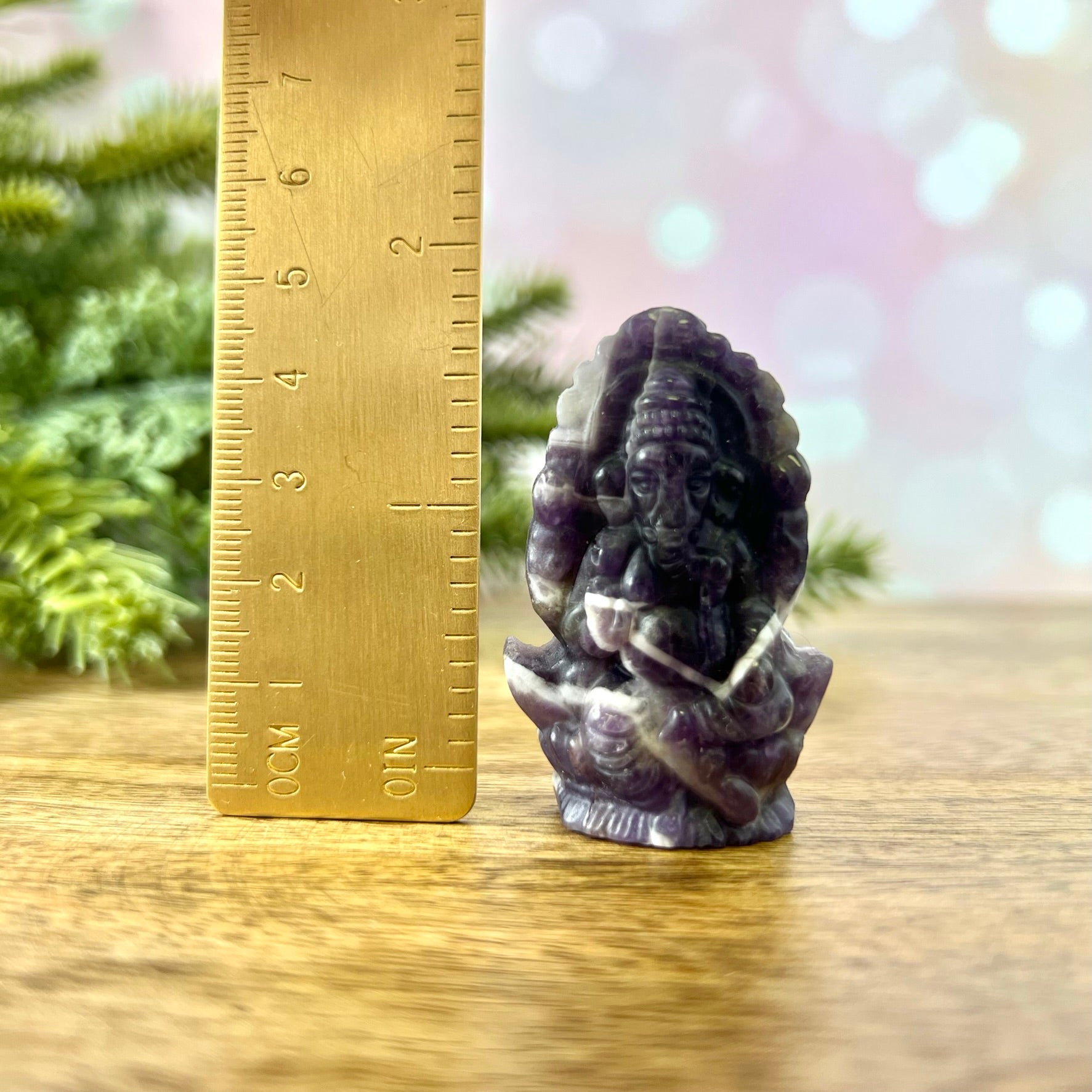 a small statue of an elephant next to a ruler