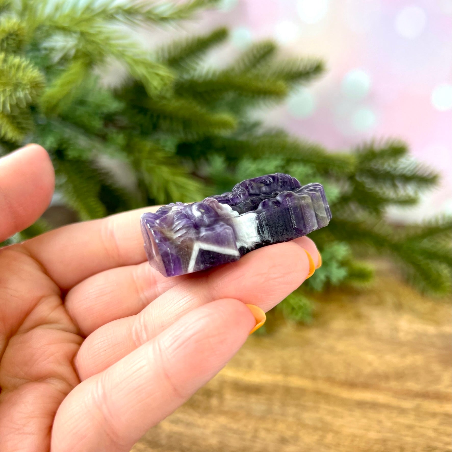 a person holding a piece of purple and white rock