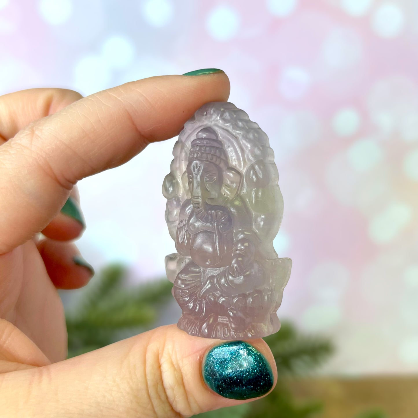 a person holding a small statue in their hand
