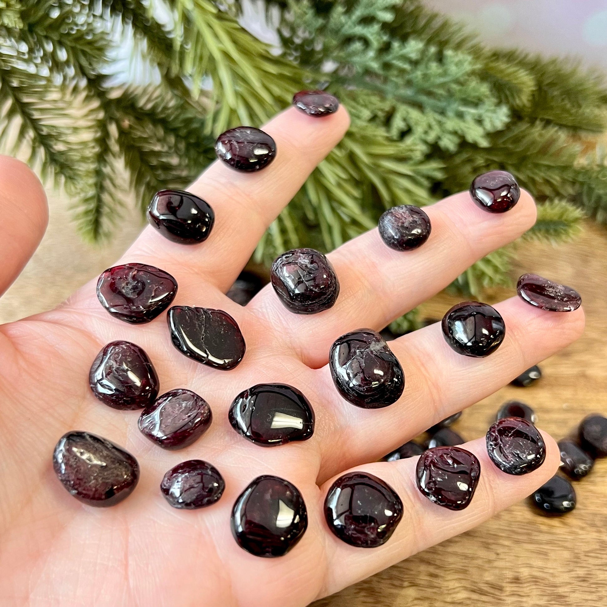 Group of small miniature tumbled crystals. They are a dark red garnet, and similar to crystal chips.