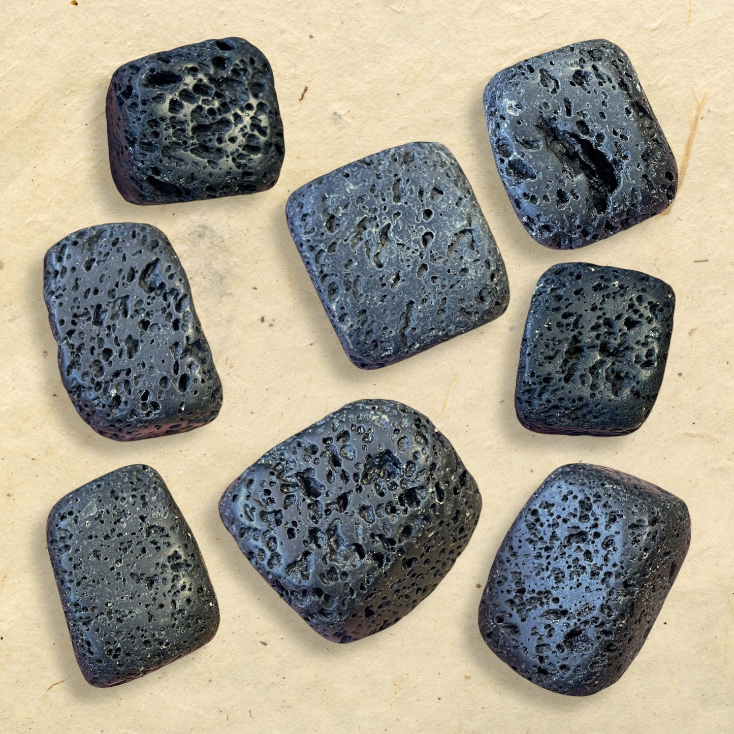 Collage of semi-polished Lava Stone crystal tumbles. They are a satin matte texture with lots of natural holes