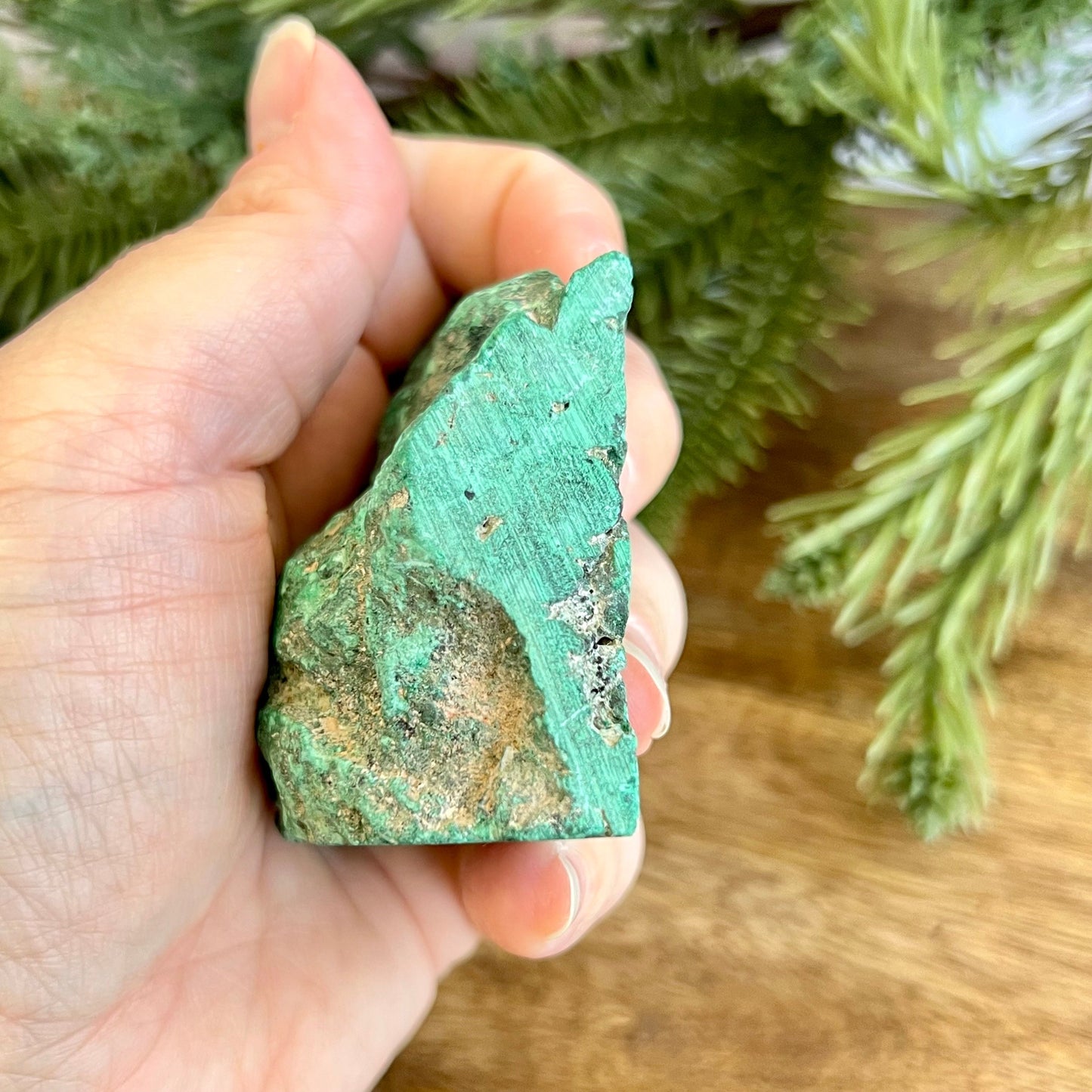 Cut slab of Malachite. Unpolished with a frosted finish. The back is natural and raw.