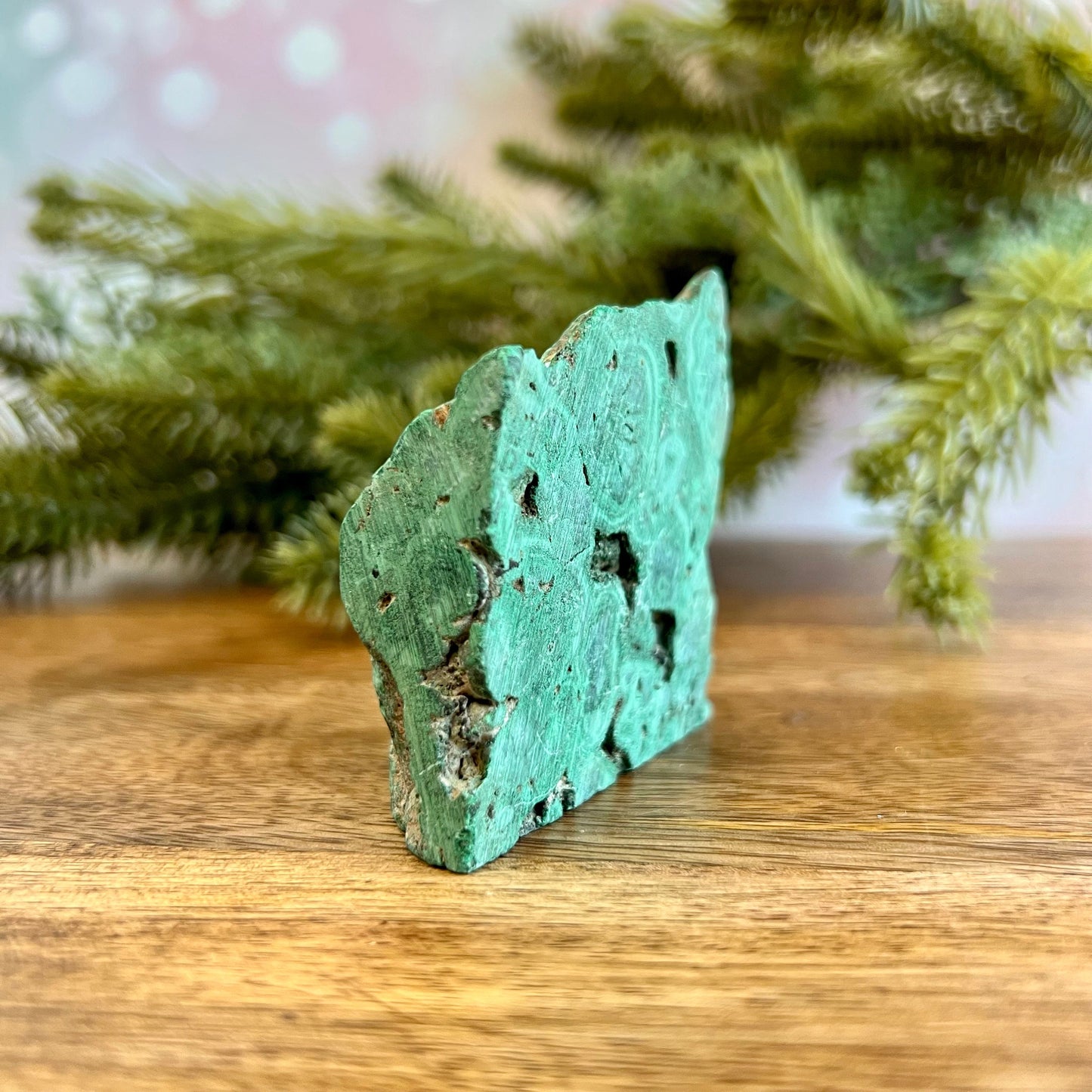 Cut slab of Malachite. Unpolished with a frosted finish. The back is natural and raw.
