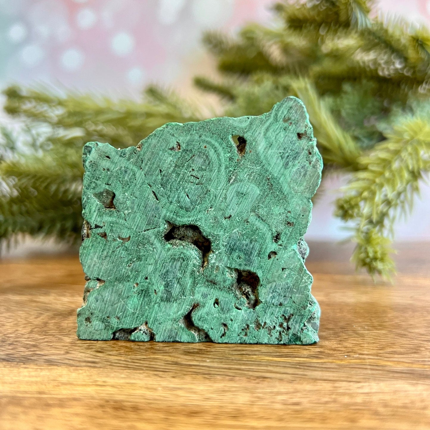 Cut slab of Malachite. Unpolished with a frosted finish. The back is natural and raw.