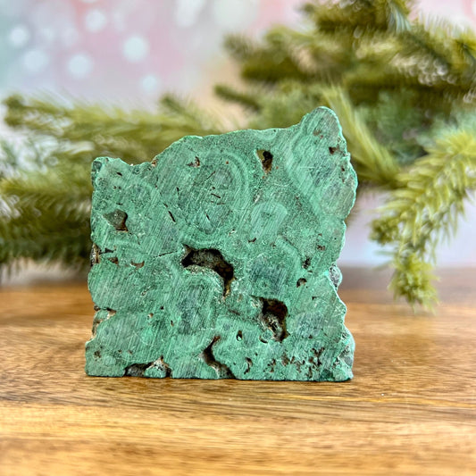 Cut slab of Malachite. Unpolished with a frosted finish. The back is natural and raw.