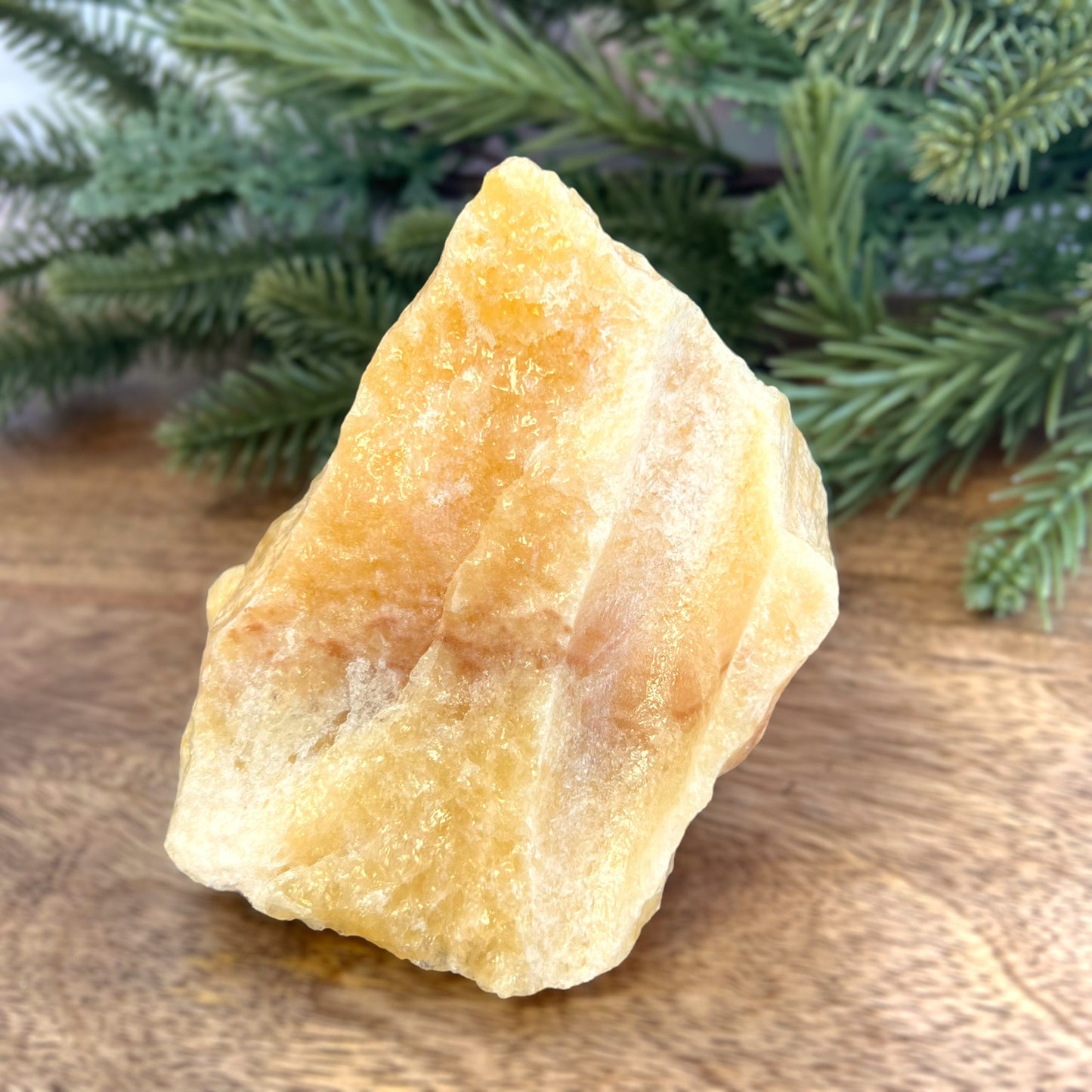 Image of a large, rough chunk piece of yellow Calcite crystal from Mexico. Very sunny color with a darker band. Rough on all edges, with a cylinder cut out on one side.