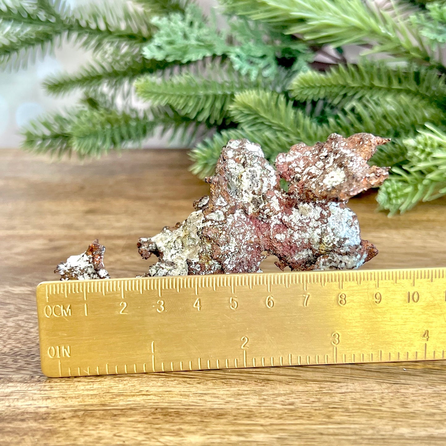 Image of a large native copper mineral specimen from Michigan. Several inches with mossy green verdigris patina on parts. Oxidized, so it's not shiny. Some dendritic formations