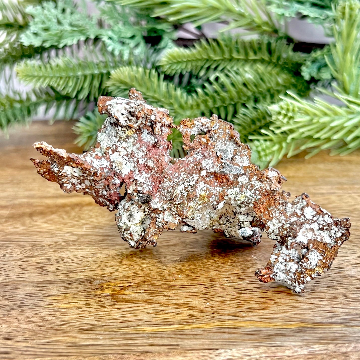 Image of a large native copper mineral specimen from Michigan. Several inches with mossy green verdigris patina on parts. Oxidized, so it's not shiny. Some dendritic formations