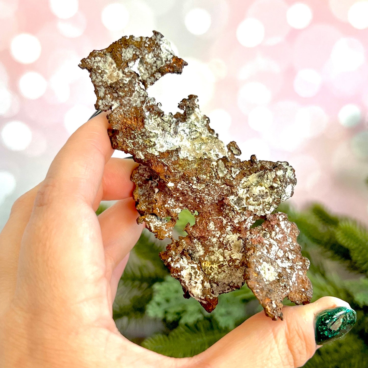 Image of a large native copper mineral specimen from Michigan. Several inches with mossy green verdigris patina on parts. Oxidized, so it's not shiny. Some dendritic formations