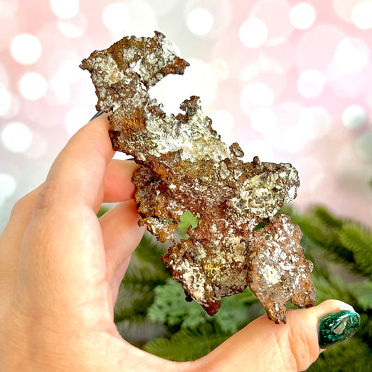 Image of a large native copper mineral specimen from Michigan. Several inches with mossy green verdigris patina on parts. Oxidized, so it's not shiny. Some dendritic formations