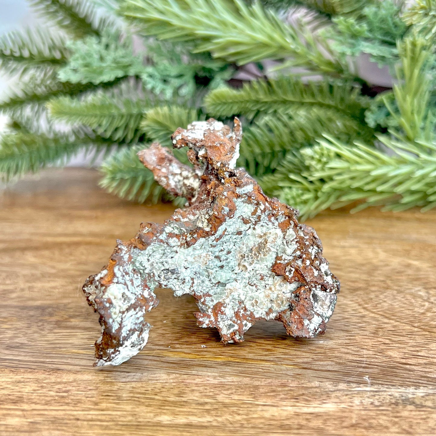 Image of a large native copper mineral specimen from Michigan. Several inches with mossy green verdigris patina on parts. Oxidized, so it's not shiny. Some dendritic formations