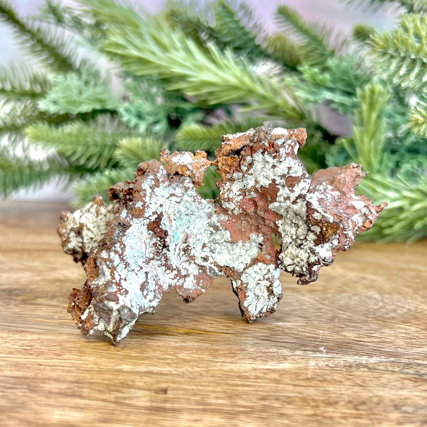 Image of a large native copper mineral specimen from Michigan. Several inches with mossy green verdigris patina on parts. Oxidized, so it's not shiny. Some dendritic formations