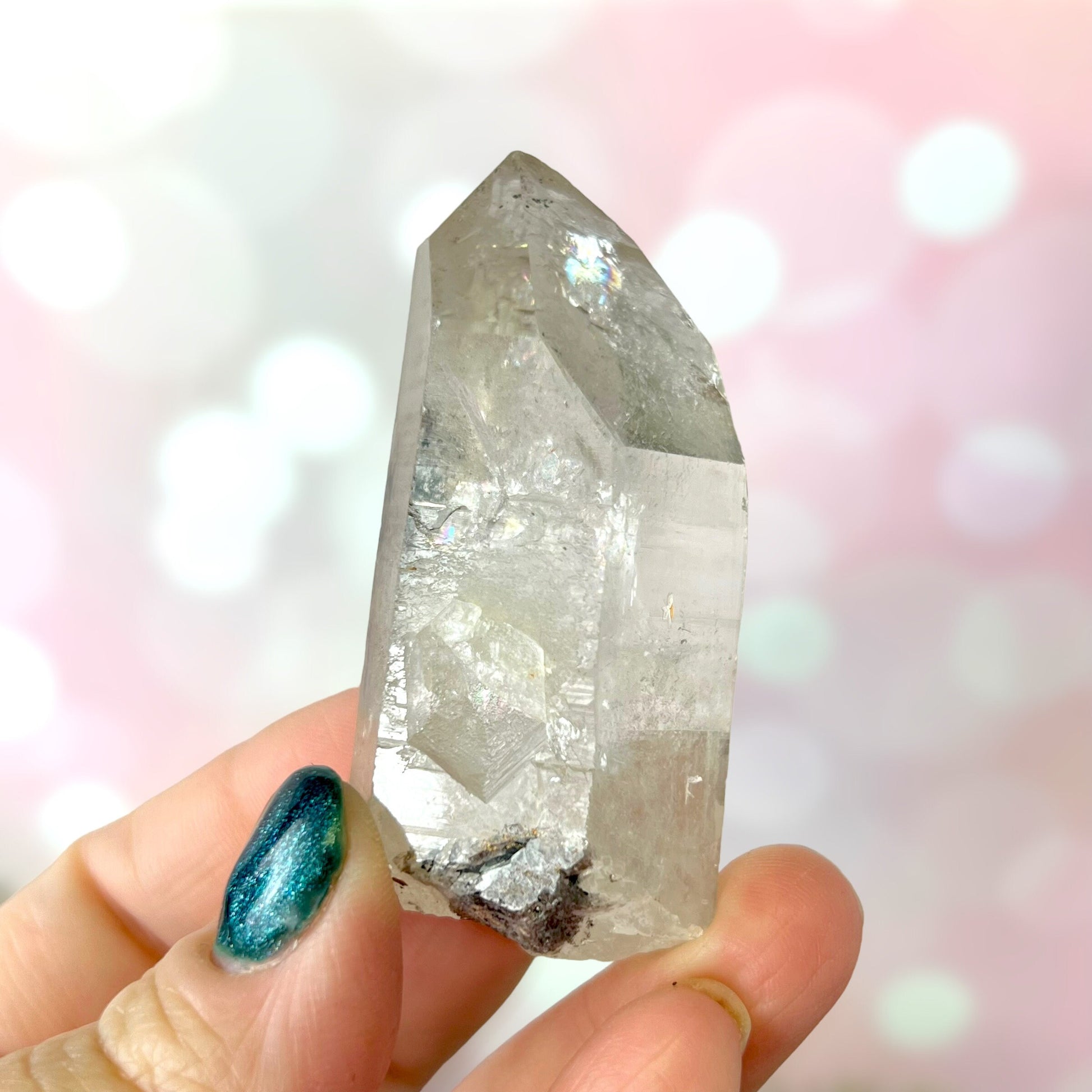 Close up of a small garden Quartz crystal point with chlorite inclusions. This mineral specimen is also called Lodolite, and is natural.