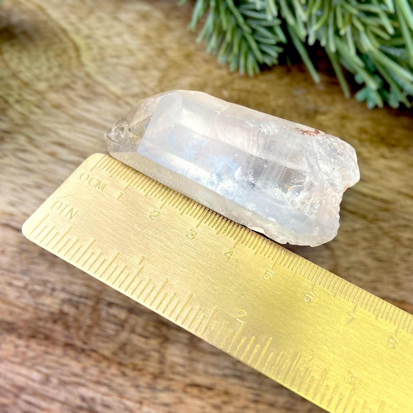 Close up of a small garden Quartz crystal point with chlorite inclusions. This mineral specimen is also called Lodolite, and is natural.