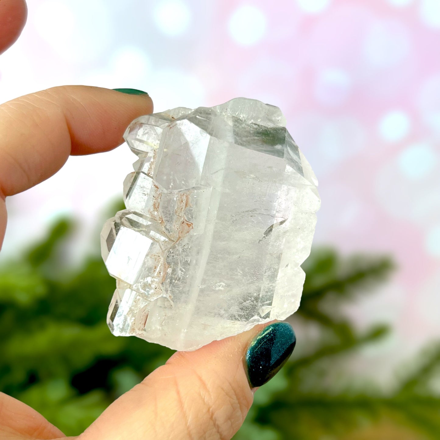 Close up of a Colombian clear Quartz crystal. It is very clear and has Lemurian horizontal lines.