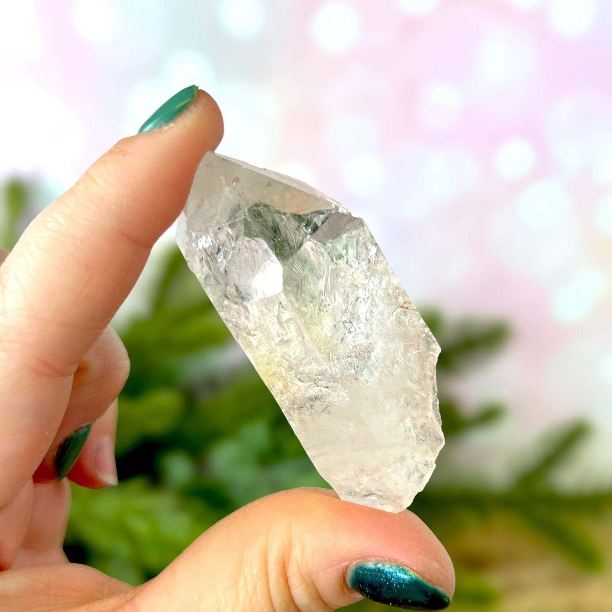 Close up of a Colombian clear Quartz crystal. It is very clear and has Lemurian horizontal lines.
