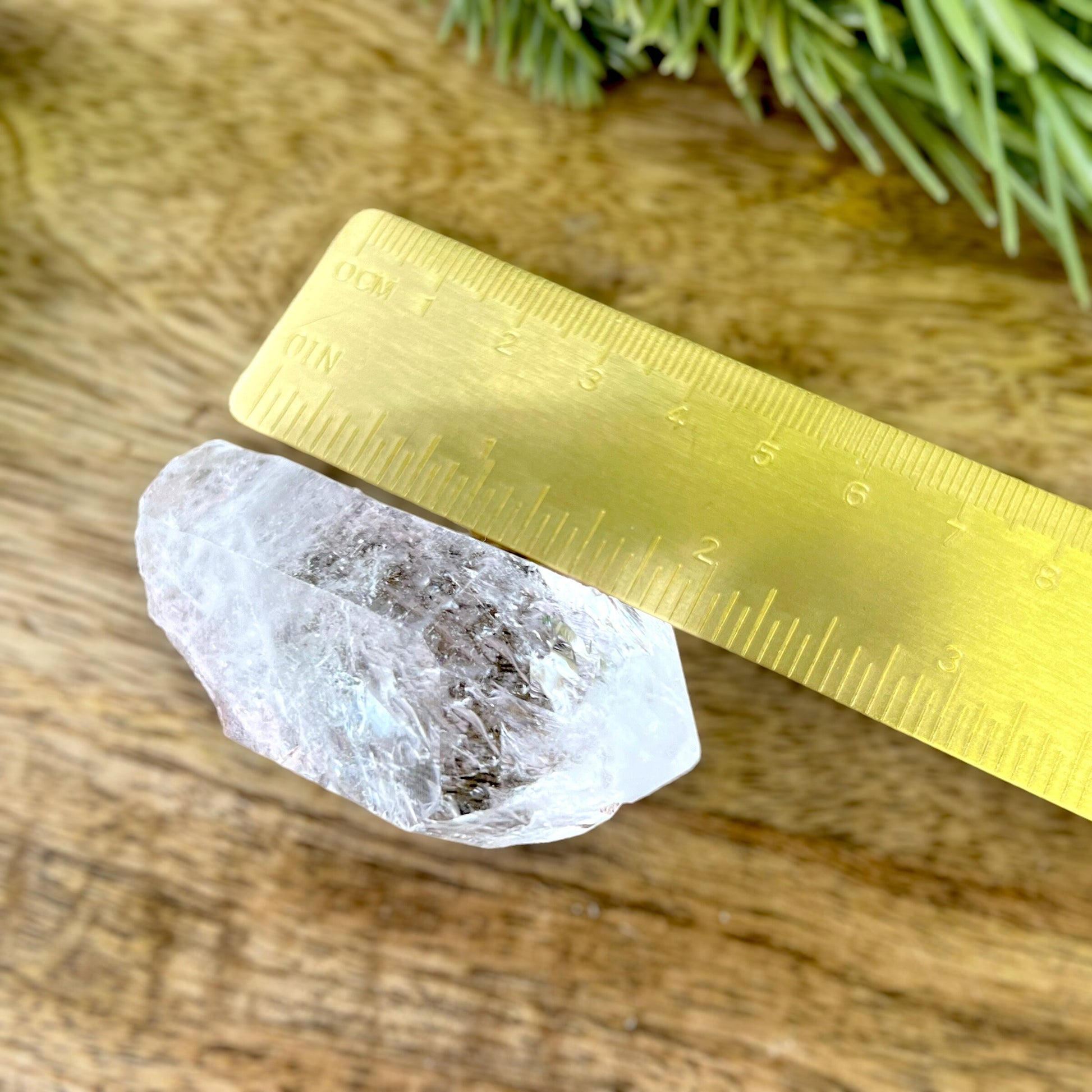 Close up of a Colombian clear Quartz crystal. It is very clear and has Lemurian horizontal lines.
