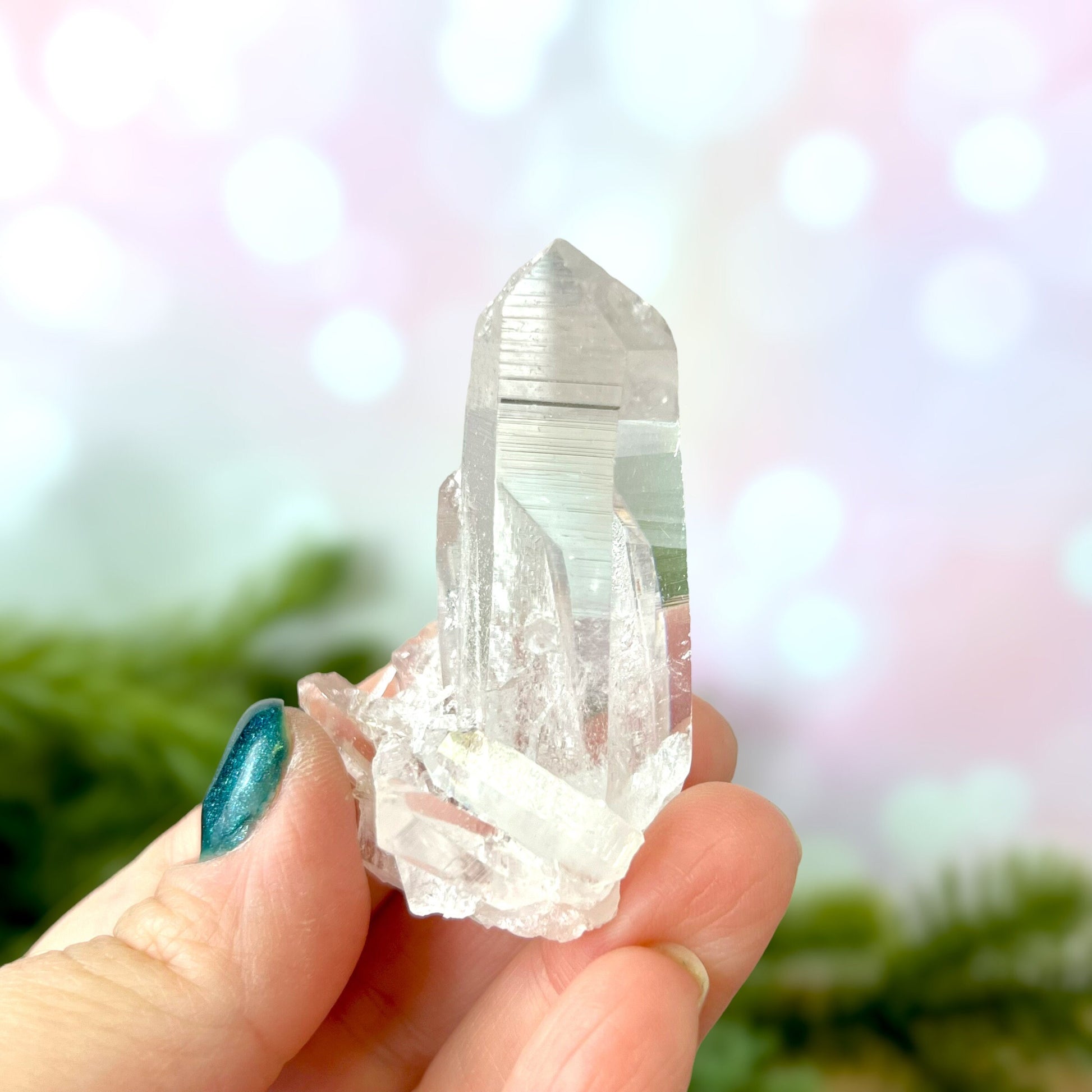 Close up of a Colombian clear Quartz crystal. It is very clear and has Lemurian horizontal lines.