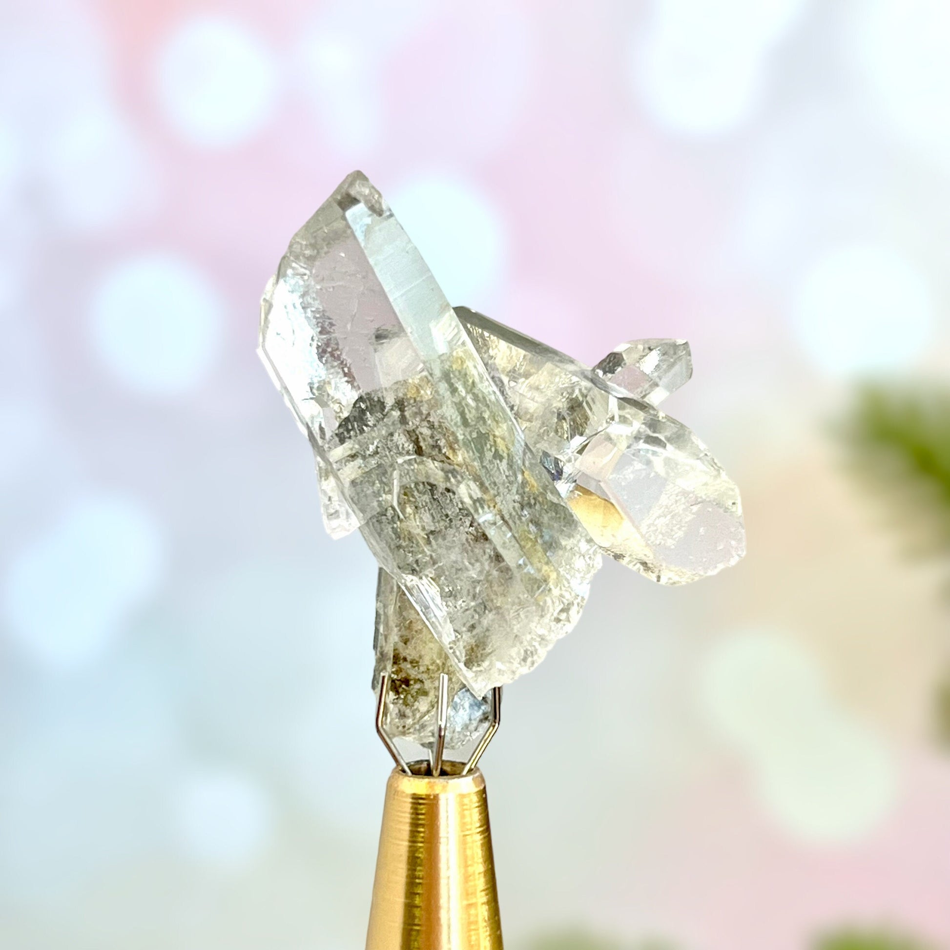 Close up of a small garden Quartz crystal point with chlorite inclusions. This mineral specimen is also called Lodolite, and is natural.