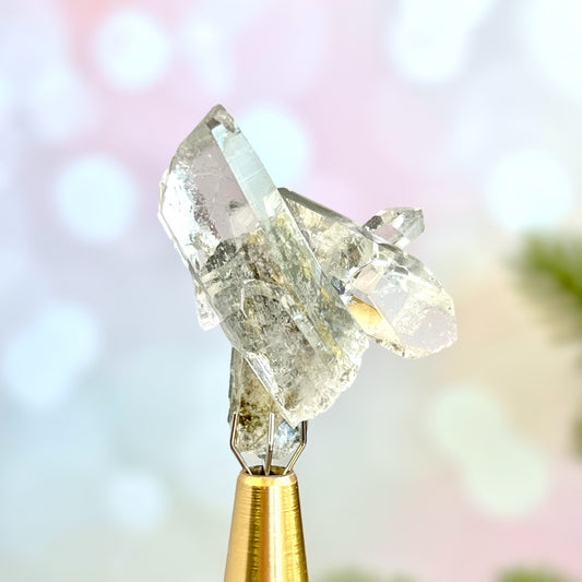 Close up of a small garden Quartz crystal point with chlorite inclusions. This mineral specimen is also called Lodolite, and is natural.
