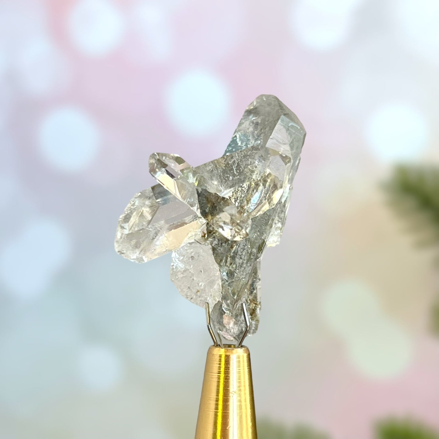 Close up of a small garden Quartz crystal point with chlorite inclusions. This mineral specimen is also called Lodolite, and is natural.