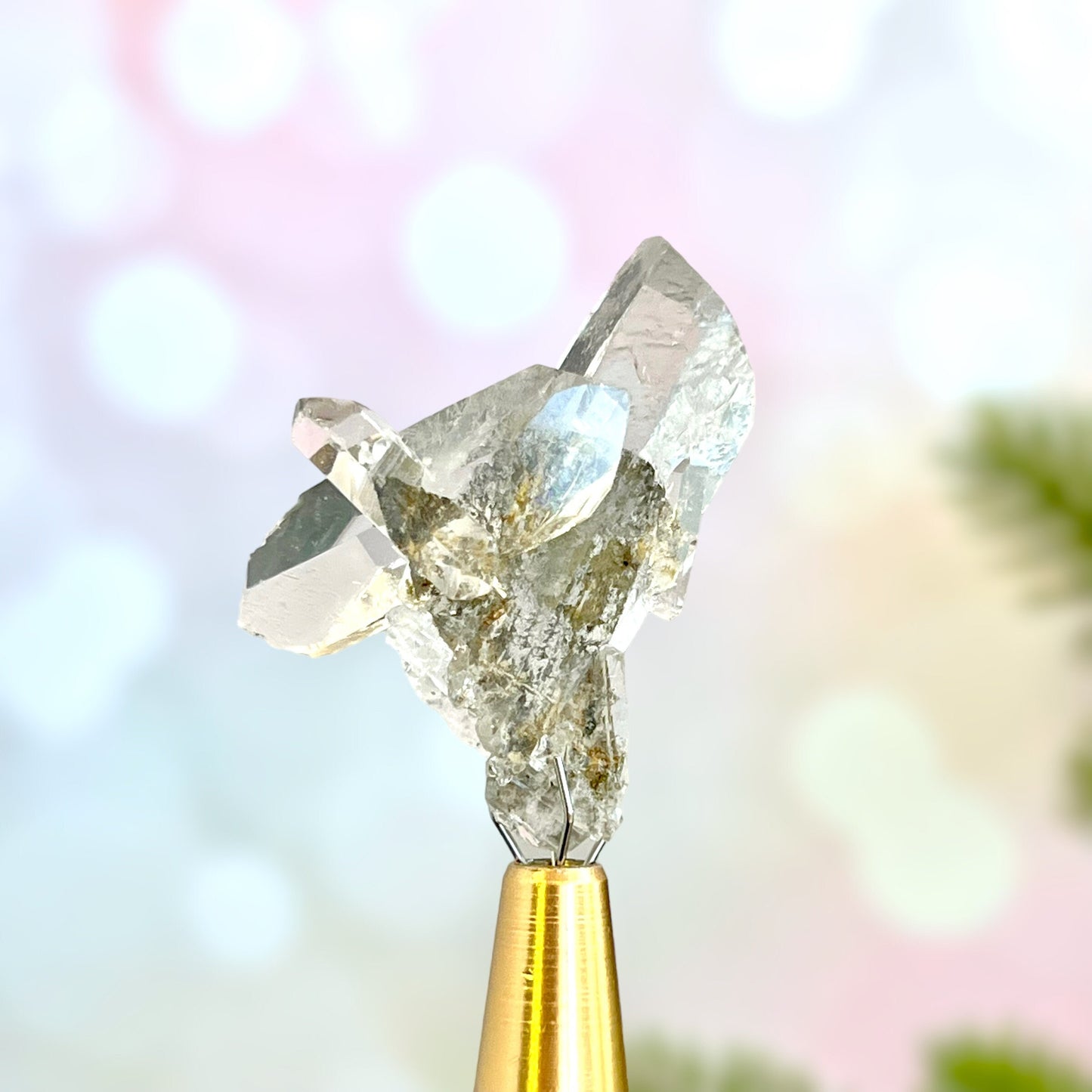 Close up of a small garden Quartz crystal point with chlorite inclusions. This mineral specimen is also called Lodolite, and is natural.