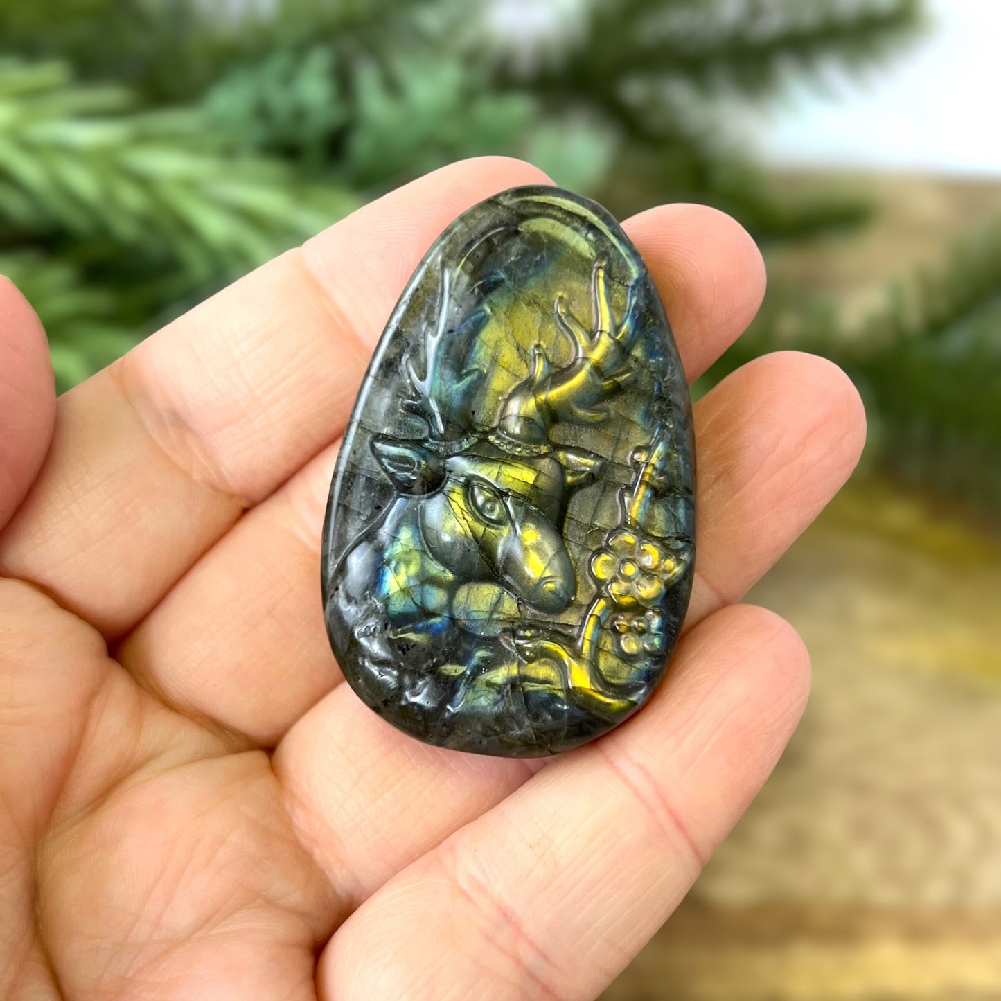 Labradorite Crystal cabochon carved into the shape of an oval teardrop, featuring a stag deer's head