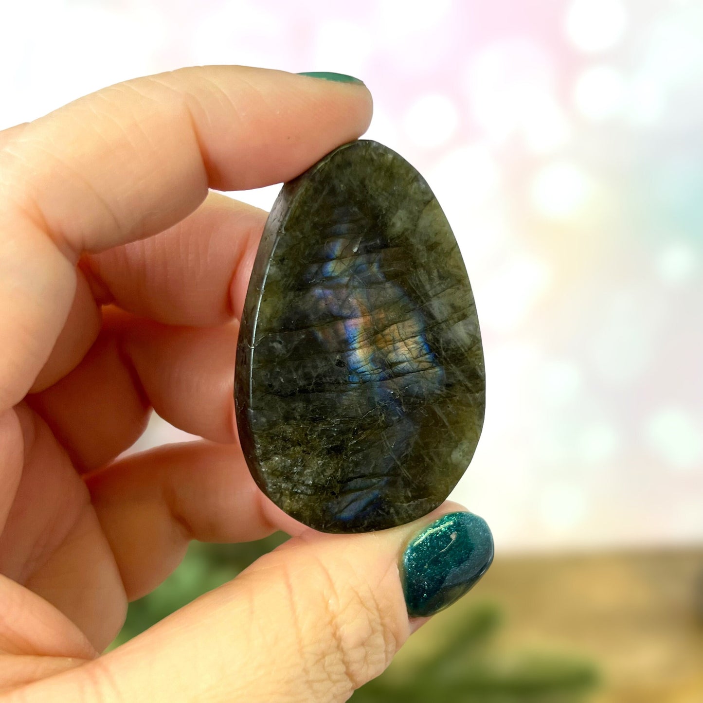 Labradorite Crystal cabochon carved into the shape of an oval teardrop, featuring a stag deer's head