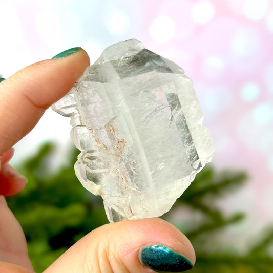 Close up of a Colombian clear Quartz crystal. It is very clear and has Lemurian horizontal lines.
