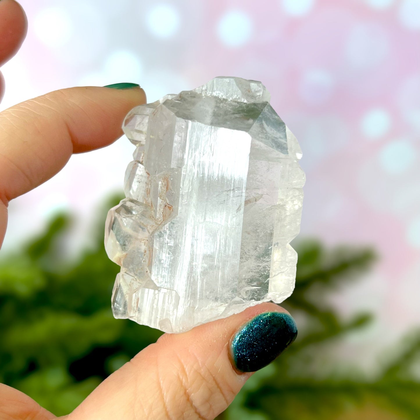 Close up of a Colombian clear Quartz crystal. It is very clear and has Lemurian horizontal lines.