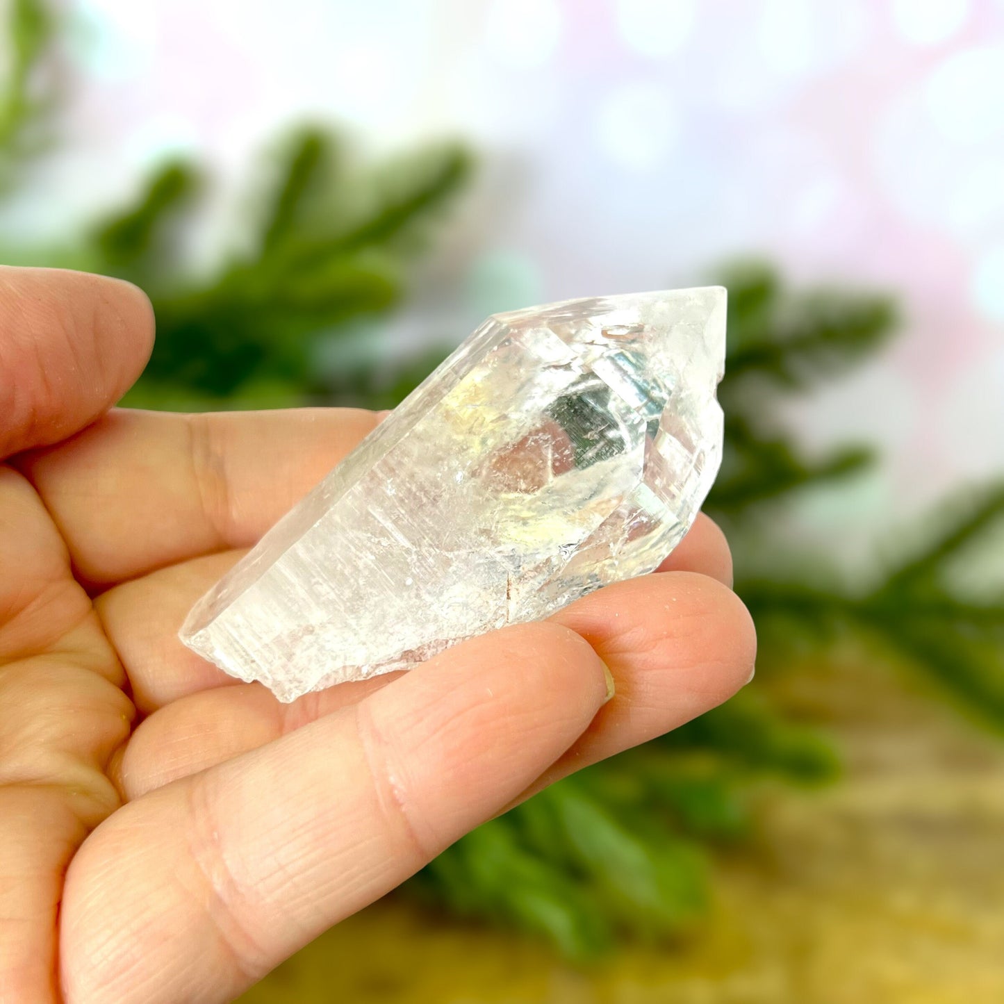 Close up of a Colombian clear Quartz crystal. It is very clear and has Lemurian horizontal lines.