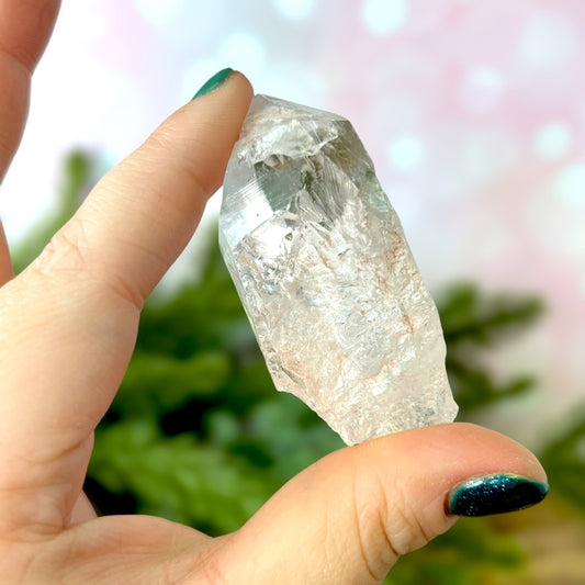 Close up of a Colombian clear Quartz crystal. It is very clear and has Lemurian horizontal lines.