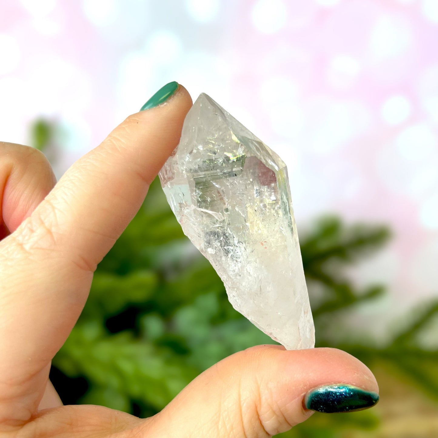 Close up of a Colombian clear Quartz crystal. It is very clear and has Lemurian horizontal lines.