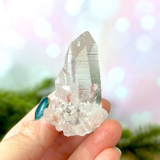 Close up of a Colombian clear Quartz crystal. It is very clear and has Lemurian horizontal lines.