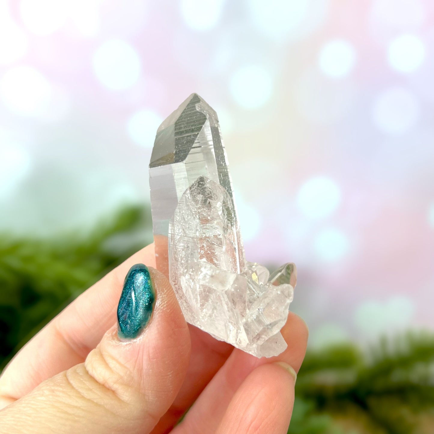 Close up of a Colombian clear Quartz crystal. It is very clear and has Lemurian horizontal lines.