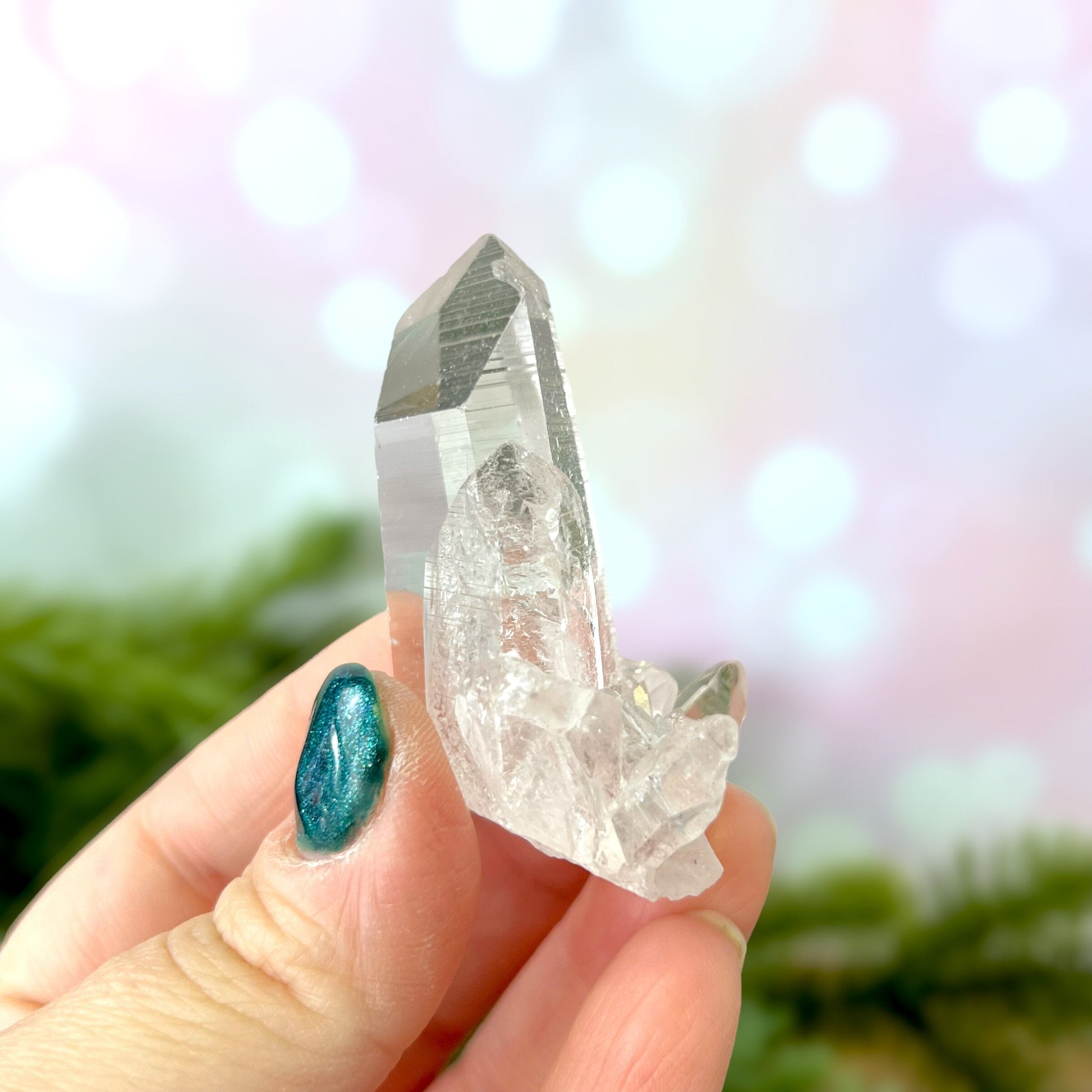 Close up of a Colombian clear Quartz crystal. It is very clear and has Lemurian horizontal lines.