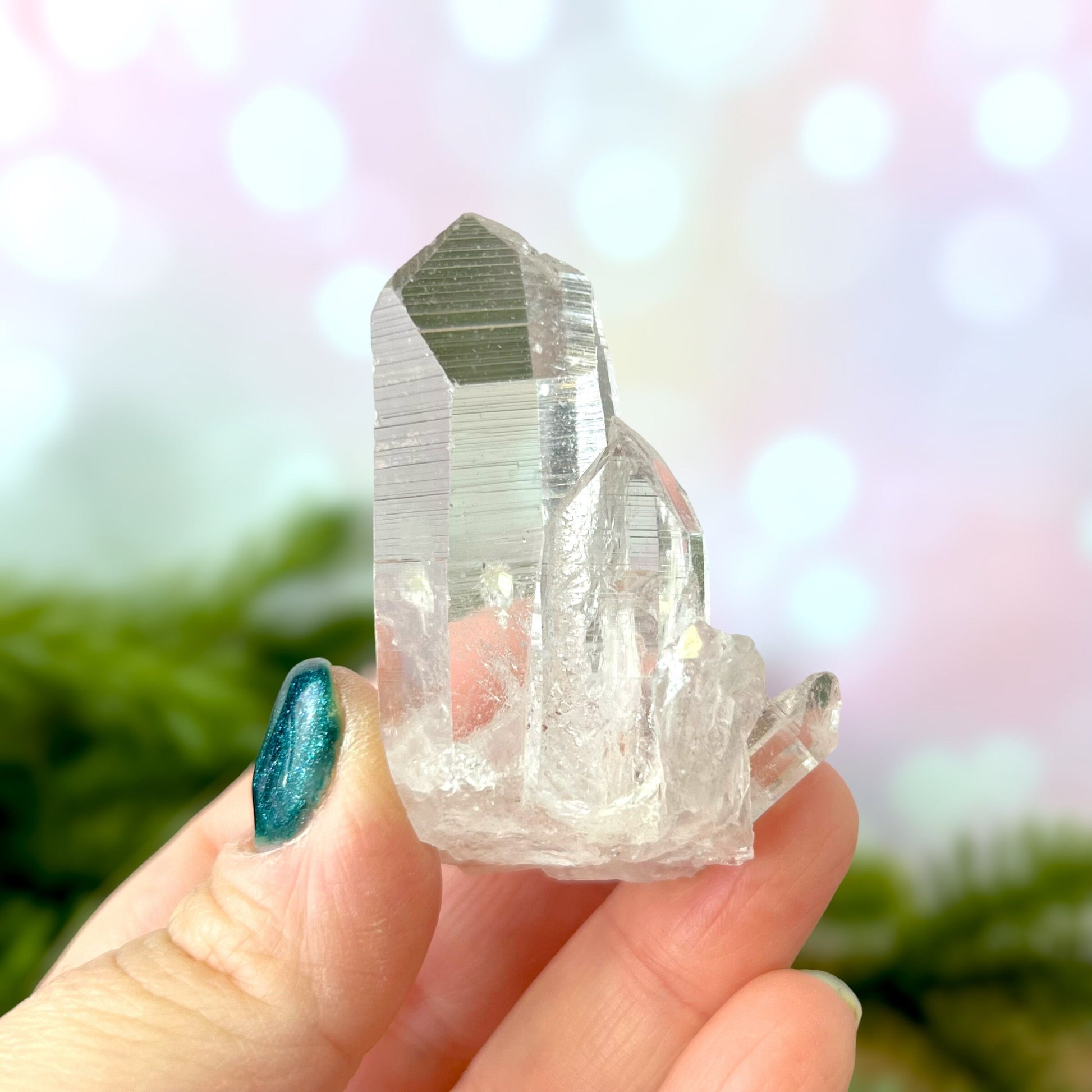 Close up of a Colombian clear Quartz crystal. It is very clear and has Lemurian horizontal lines.