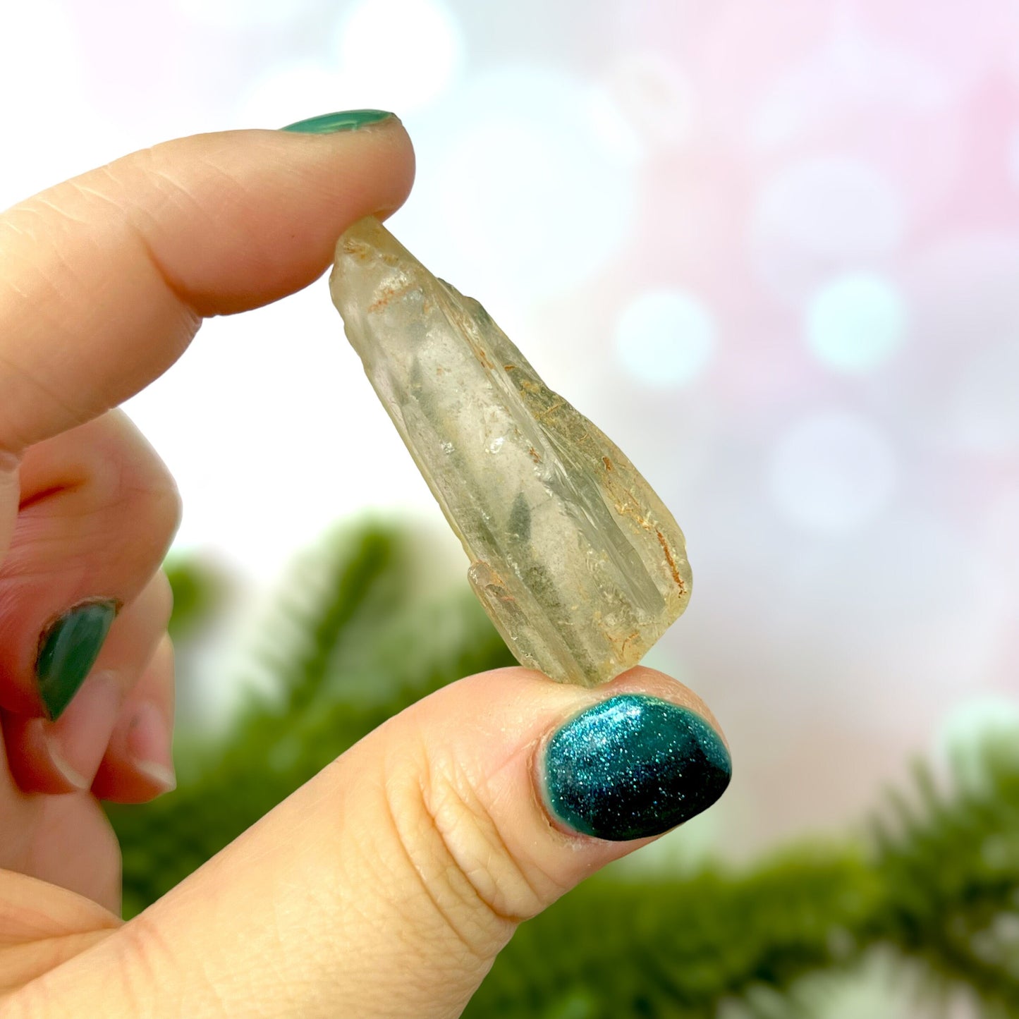 Close up of a small garden Quartz crystal point with chlorite inclusions. This mineral specimen is also called Lodolite, and is natural.