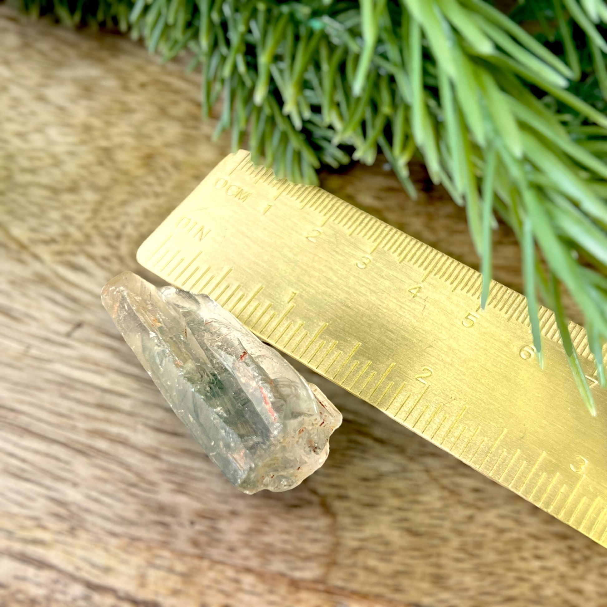 Close up of a small garden Quartz crystal point with chlorite inclusions. This mineral specimen is also called Lodolite, and is natural.
