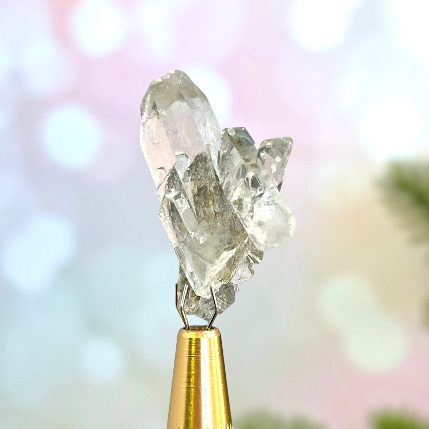 Close up of a small garden Quartz crystal point with chlorite inclusions. This mineral specimen is also called Lodolite, and is natural.