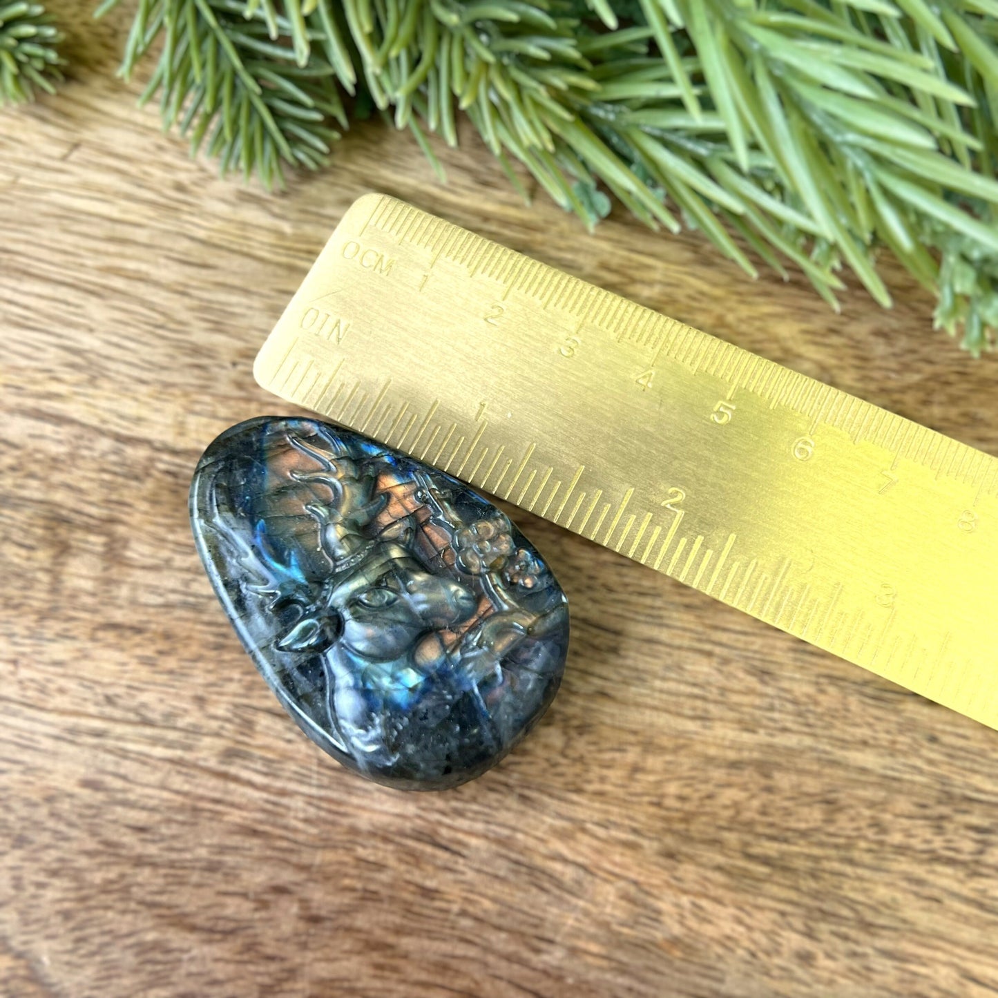 Labradorite Crystal cabochon carved into the shape of an oval teardrop, featuring a stag deer's head