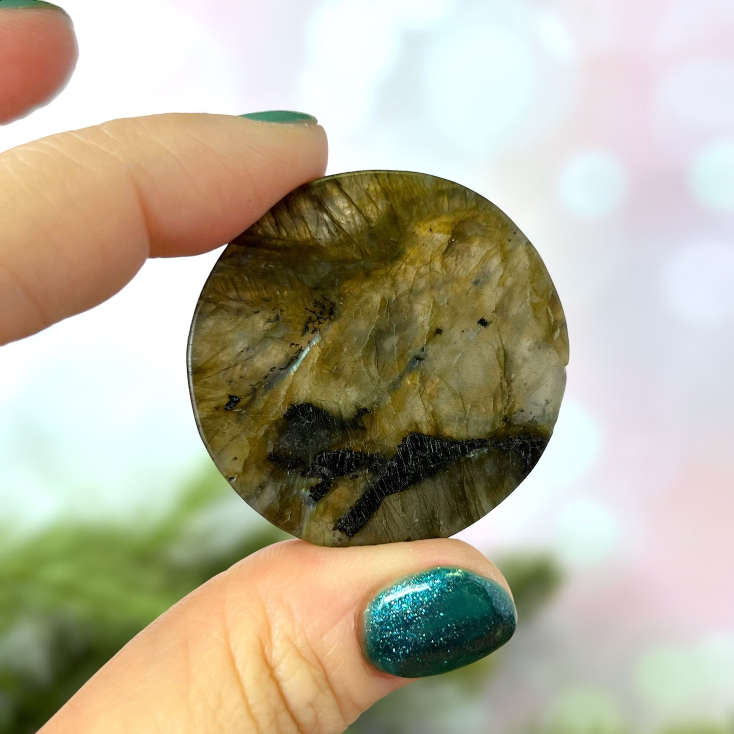 Labradorite Crystal cabochon carved into a circle. Features a unicorn head looking at a butterfly