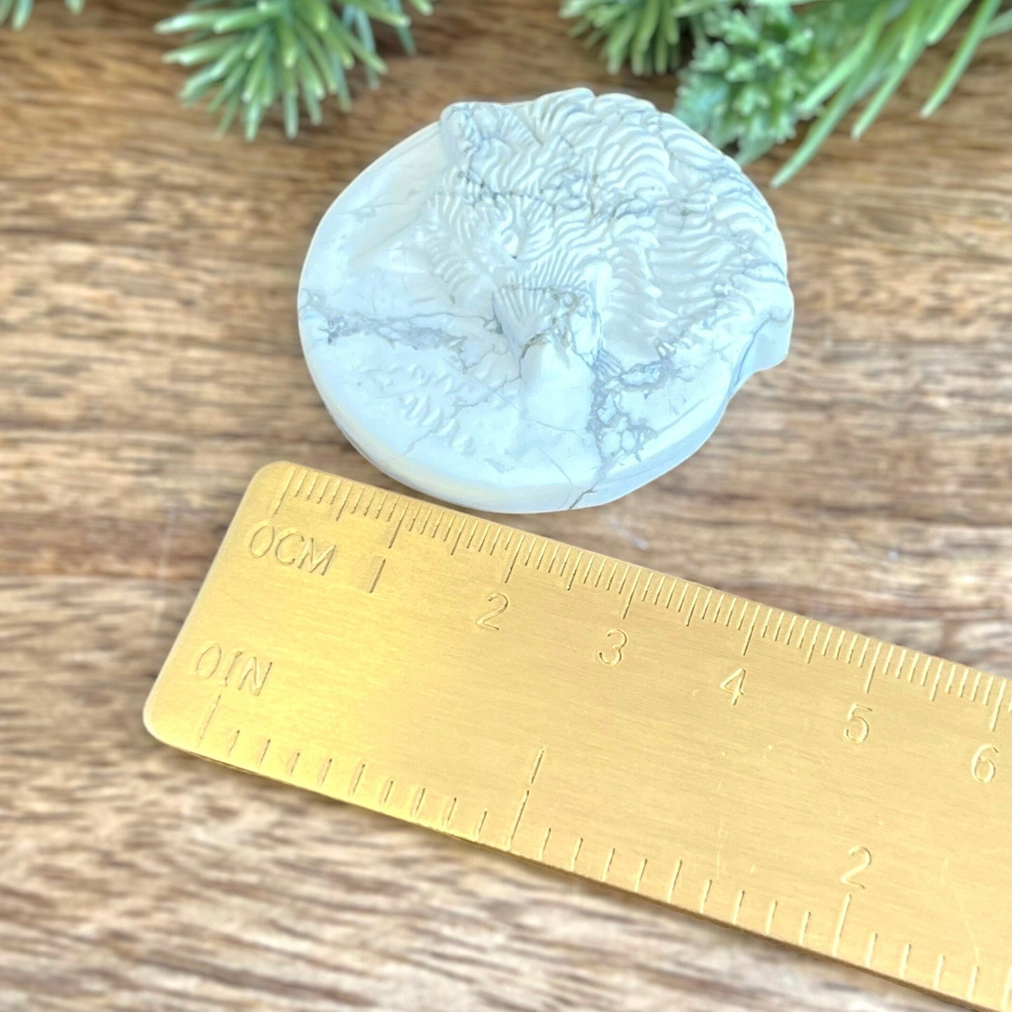 Natural and authentic Magnesite carved crystal cabochon. This Stone Cabochon has been carved into a wolf against a circular Moon.