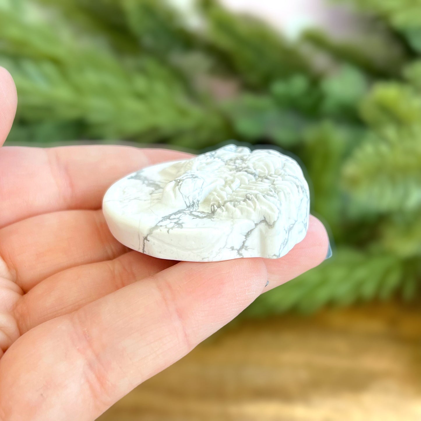 Natural and authentic Magnesite carved crystal cabochon. This Stone Cabochon has been carved into a wolf against a circular Moon.