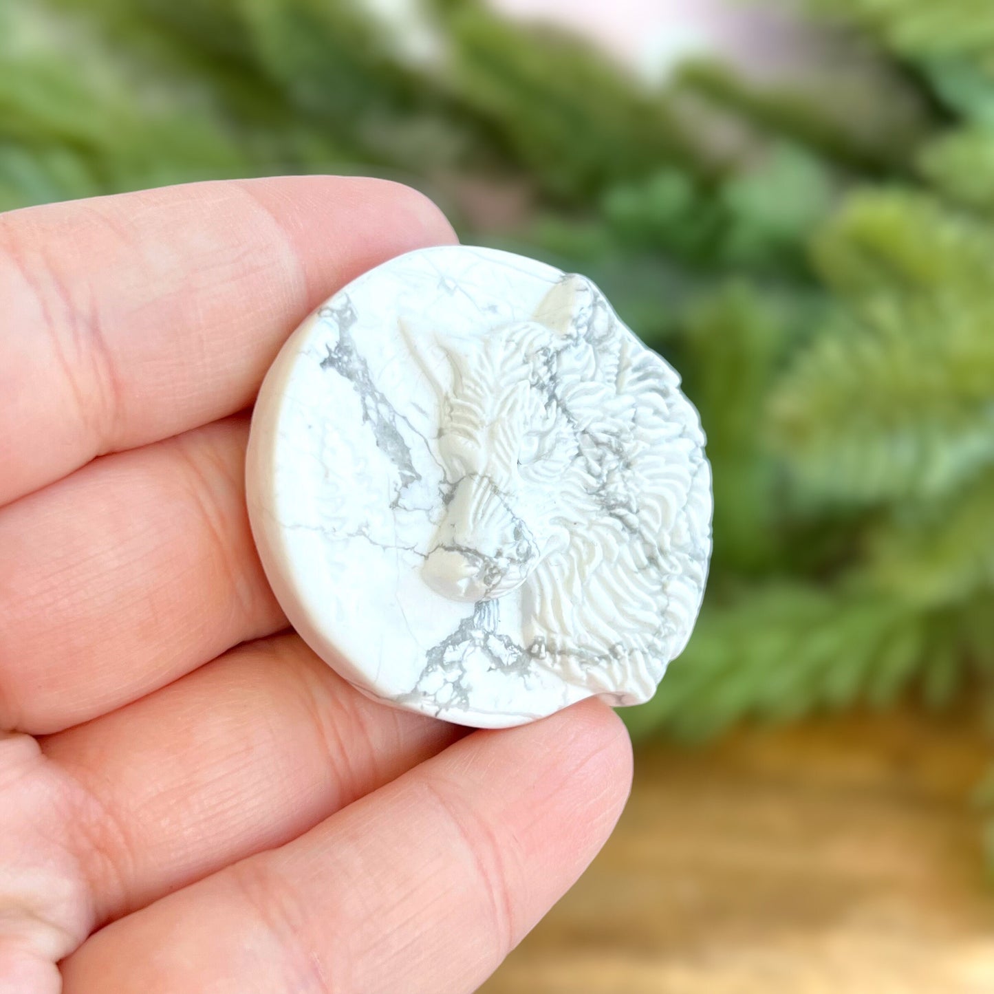Natural and authentic Magnesite carved crystal cabochon. This Stone Cabochon has been carved into a wolf against a circular Moon.