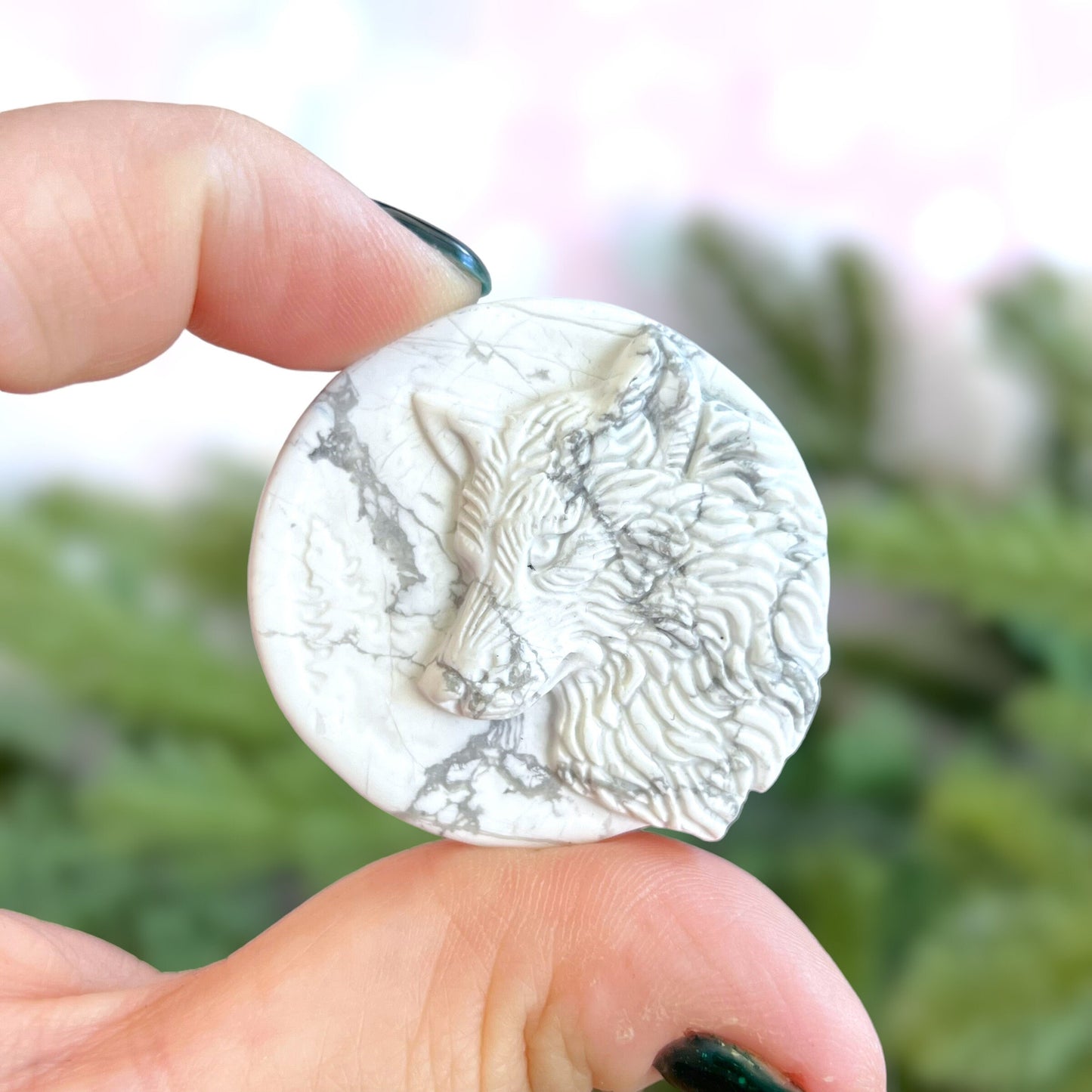 Natural and authentic Magnesite carved crystal cabochon. This Stone Cabochon has been carved into a wolf against a circular Moon.