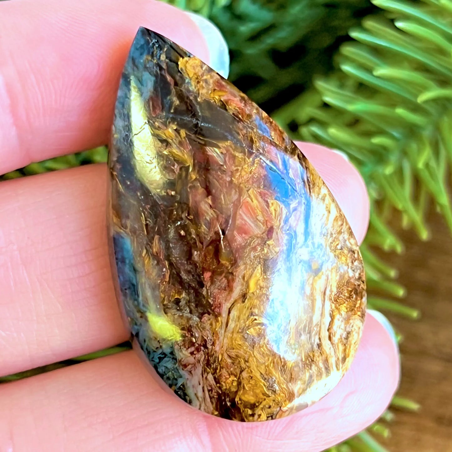 Swirling Pietersite teardrop cabochon in red, gold, and blue